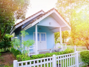 little house garden / Blue house cottage garden summer in green plant and tree background