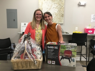 Casey S (right) picking up the Calcagni gift basket she won at the 1st Annual Wing Fest presented by Wallingford Center Inc and Calcagni